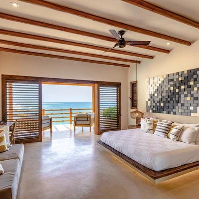 Bedroom with outdoor living space and sea views.